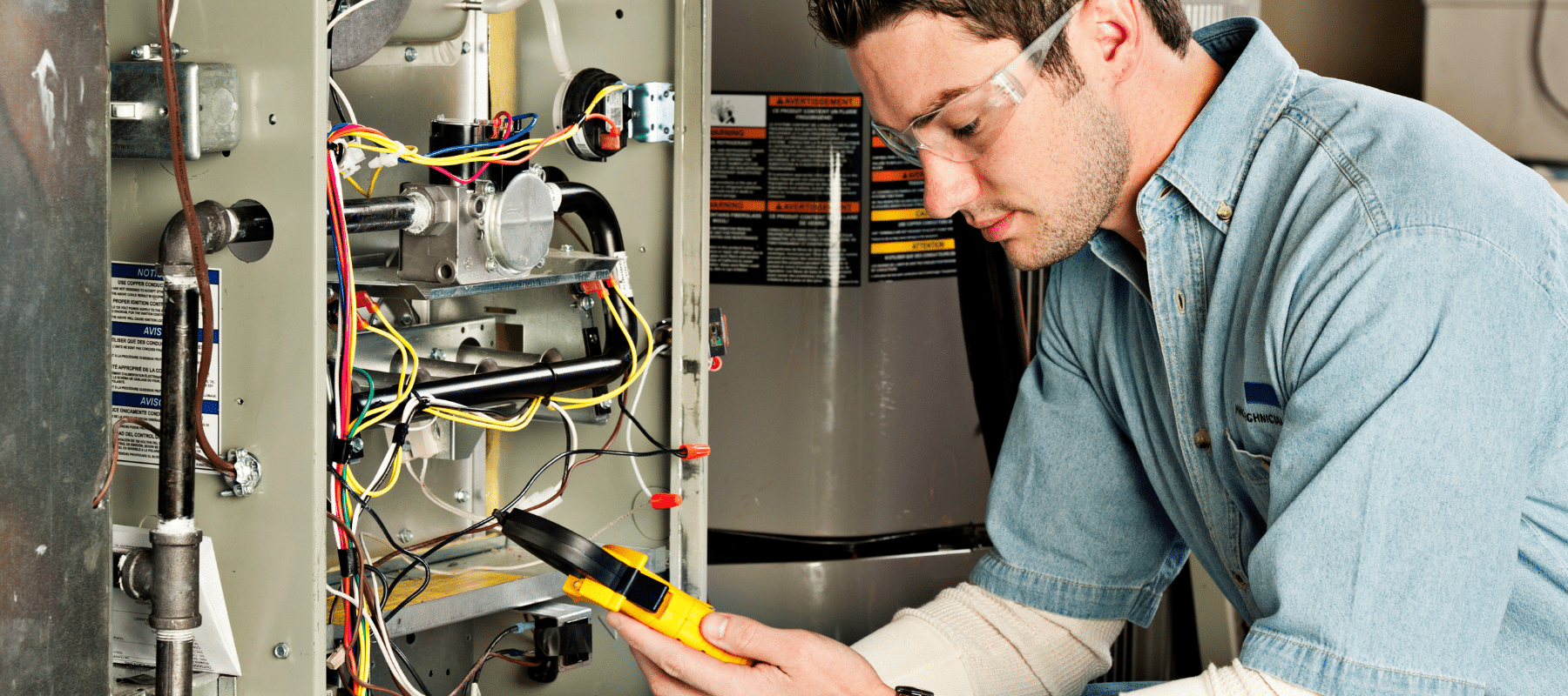 closeup of a technician checking a furnace